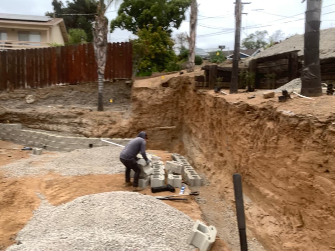 Backyard trench and leveling process for hardscape foundation