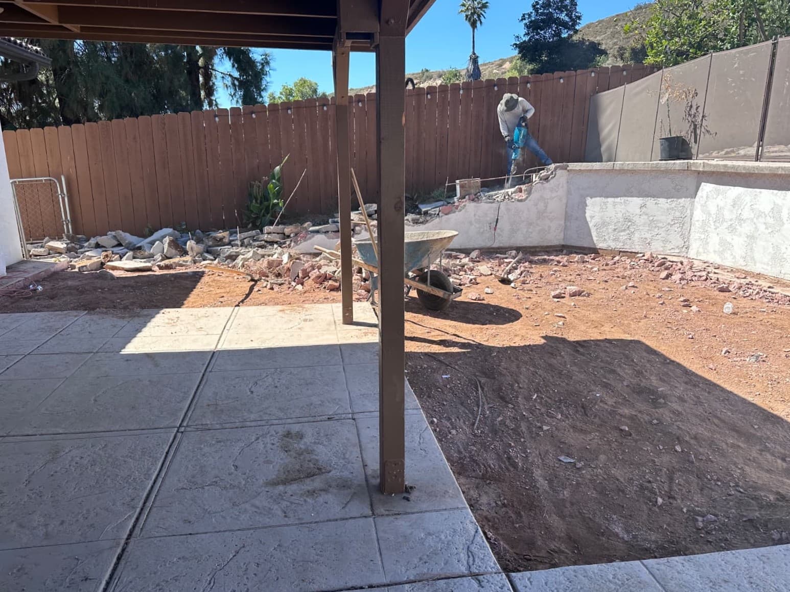 Backyard construction site showing framing and prep work for new hardscape patio installation